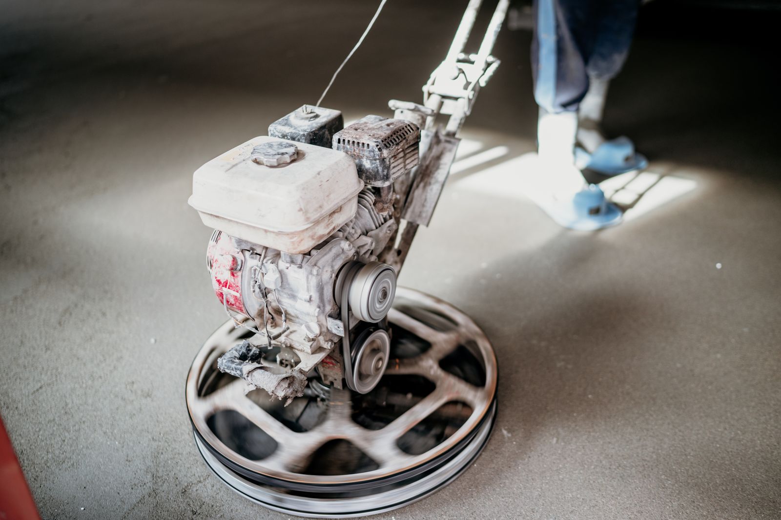 Diamond grinding machine preparing a concrete slab for coating